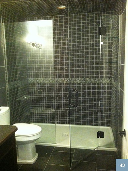 Blue tiled shower with glass sides